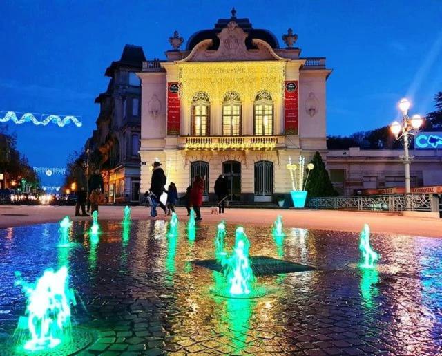 a building with a fountain in front of it at night at Camping 3 étoiles - Piscine - ccbgaig in Loubeyrat
