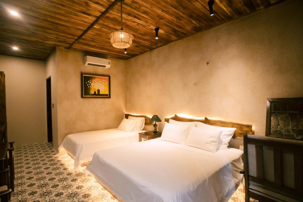 a bedroom with two beds in a room at Laco Green Trang An in Yên Ha