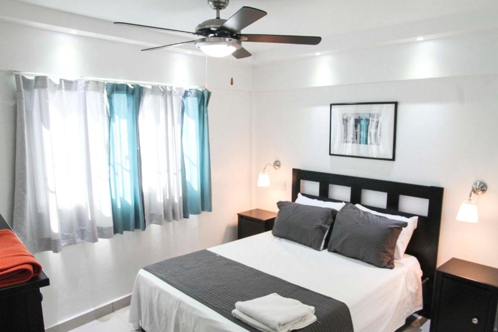 A bed or beds in a room at City Caribbean Hotel Boutique
