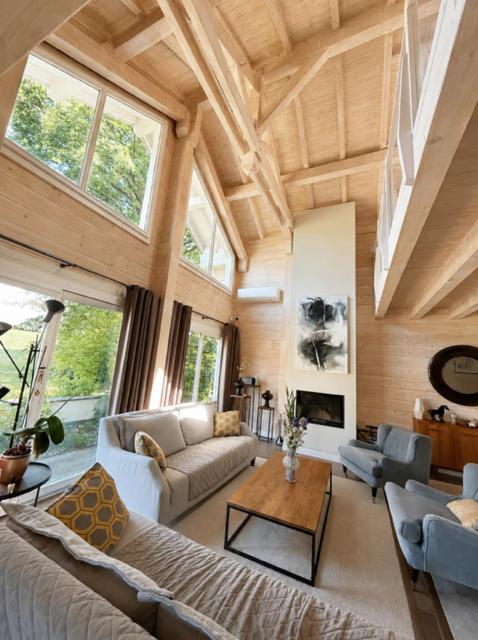 a living room with a couch and a table at Modern chalet next to Geneva in Divonne-les-Bains