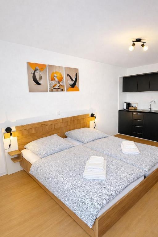 a bedroom with a large bed with two white towels at Ado Pension in Wedel