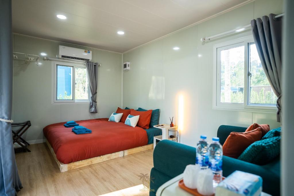 a bedroom with a bed and a couch at Kood Friends Koh Kood in Ko Kood