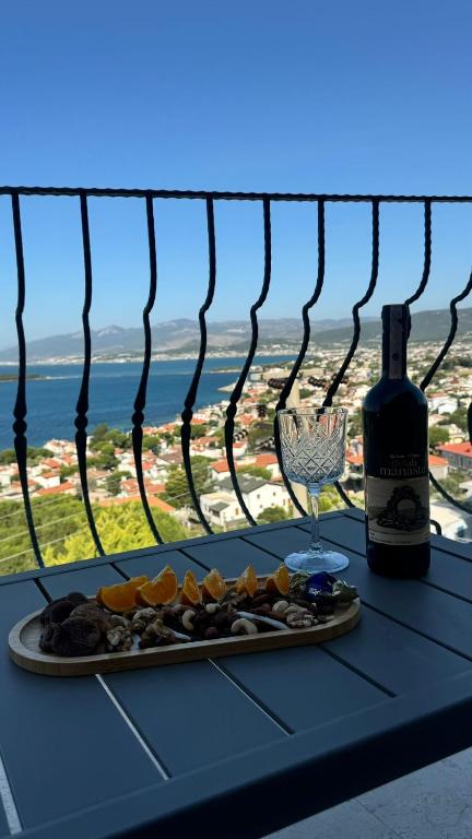 a table with a plate of food and a bottle of wine at Terrace Urla in Urla