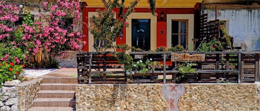 a house with a bunch of flowers in front of it at HARI'S NEST CORFU in Marathias