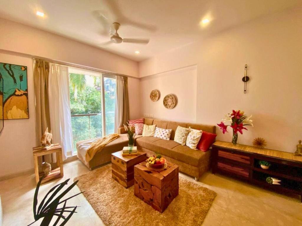 a living room with a couch and a table at Modern 2bed Bandra AreaParkingUnit 2 in Mumbai