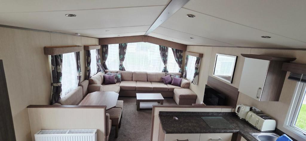 a living room in an rv with a couch and a table at The Minver - Park Dean Resort in Saint Minver