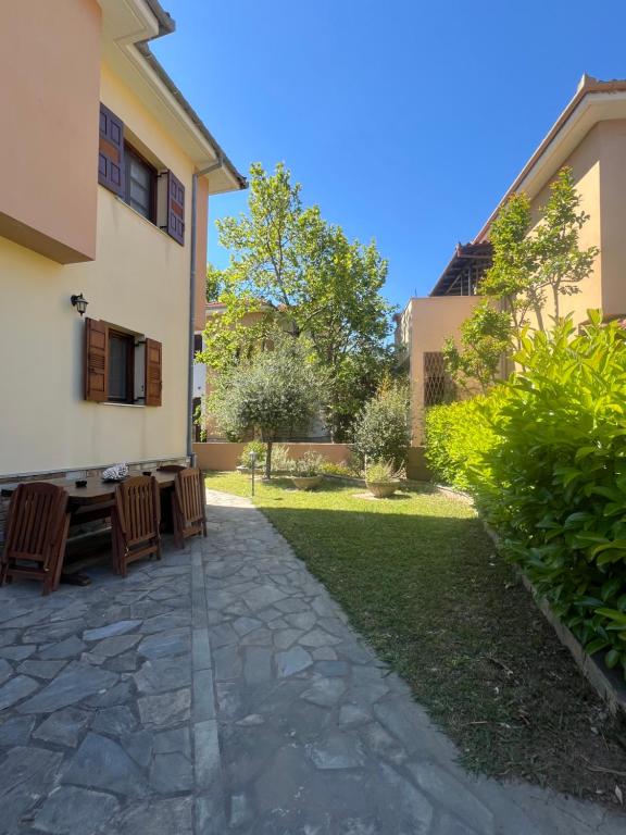 a patio with chairs and a table in a yard at Villa Apanemi in Kala Nera