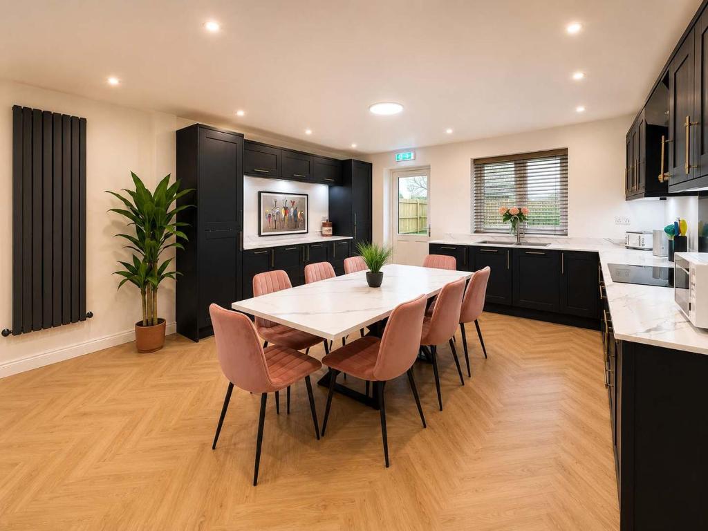 a kitchen with a table and chairs in a room at The Blackhorse Windsor in Dorney