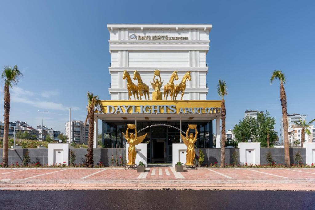 a building with a gold sign in front of it at Daylights Apart Otel in Antalya