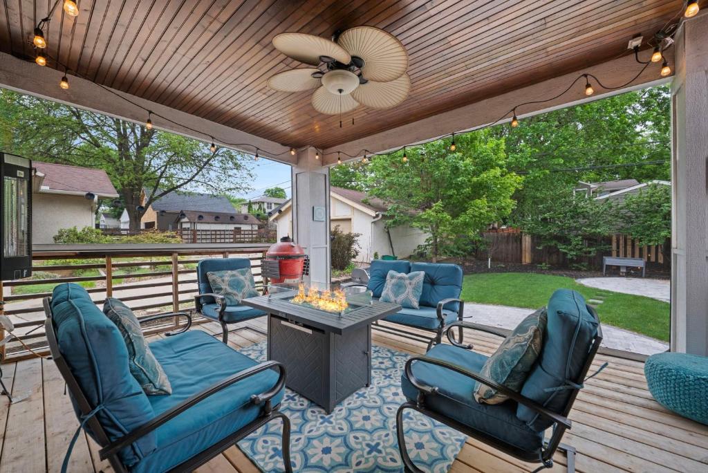 a patio with blue chairs and a ceiling fan at Casa Roja in Edina