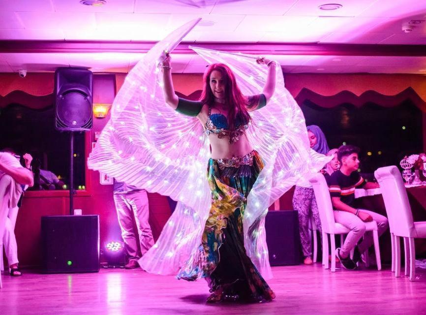 a woman in a butterfly costume on a dance floor at BOSPHOROUS DİNNER CRUISe in Istanbul