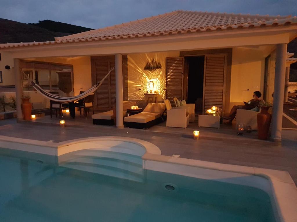 a villa with a swimming pool at night at Sol e Luna in Ponta