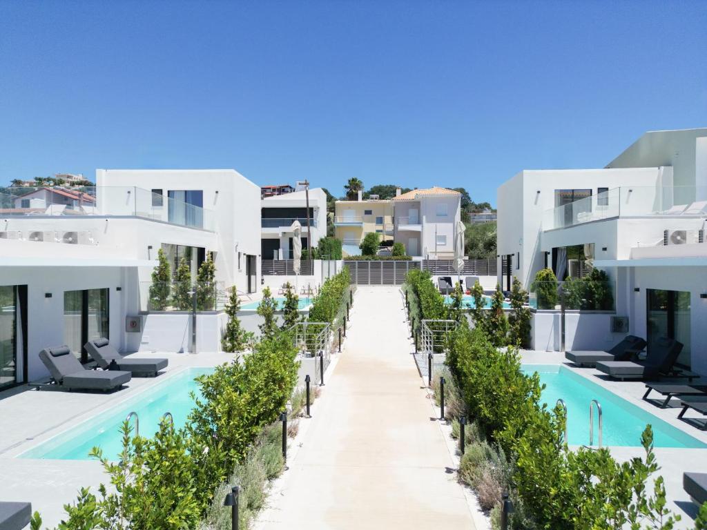 an image of the front of a hotel with a swimming pool at Sole Azzurro Villas in Kanali