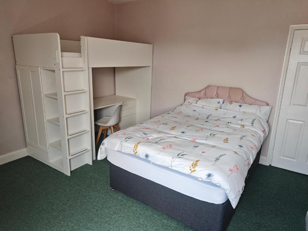 a small bedroom with a bed and a book shelf at St Peters Avenue in Cleethorpes