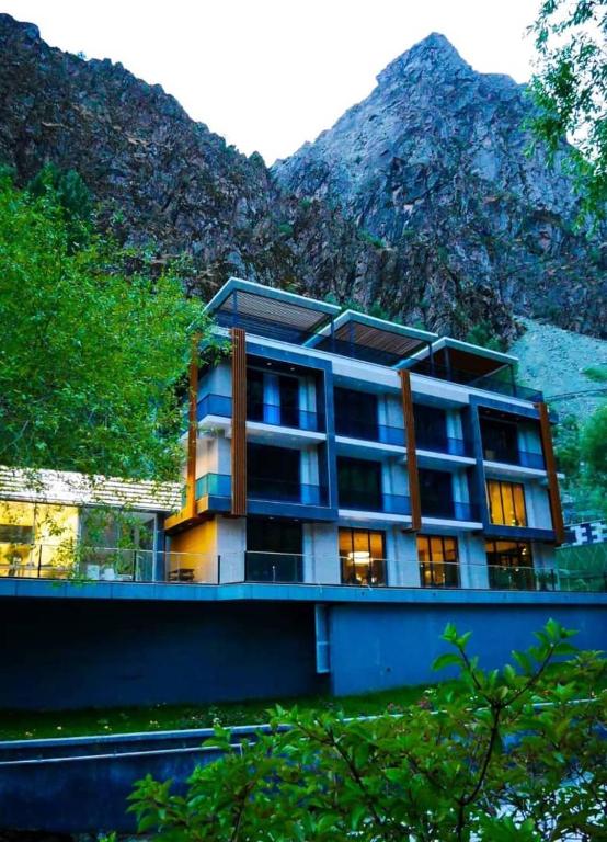 a building with a mountain in the background at Chorchaman Hills in Patkunob