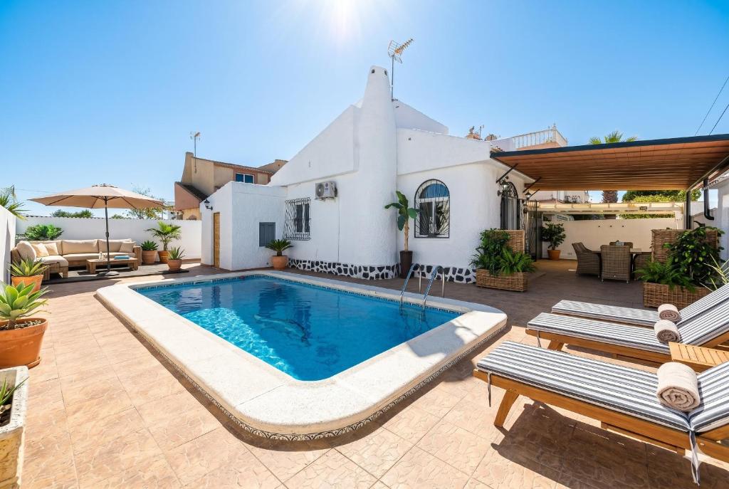 a swimming pool in the middle of a patio at Chalet Queen Venecia Sunrise in Campoamor