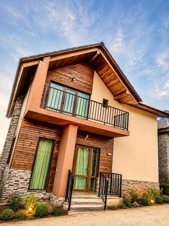 a house with a balcony on top of it at Wonder Hill group in Bakuriani