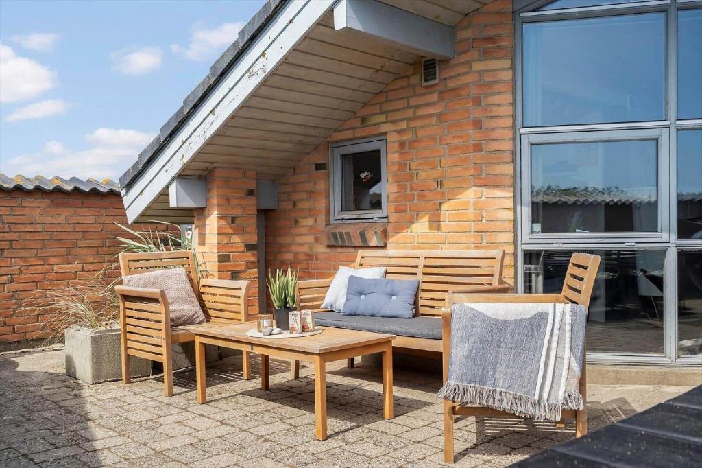 a patio with a couch and a table and chairs at 461-Hvide-Sande-Tingodden-152 in Hvide Sande