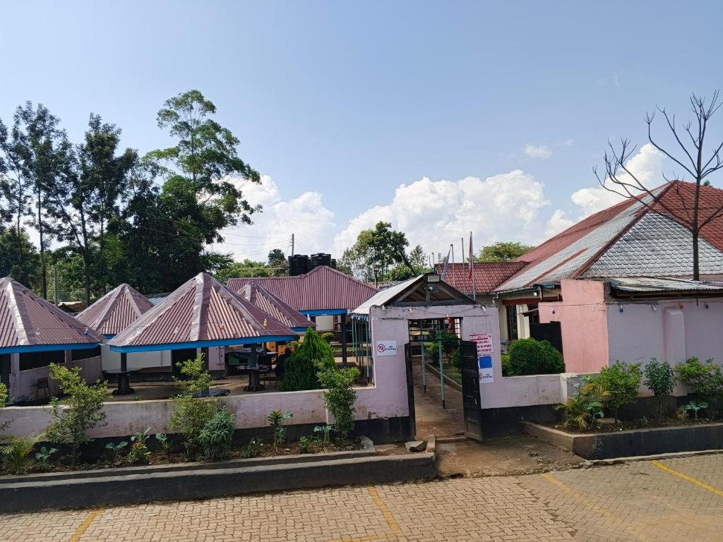 a row of houses with roofs at Chwele Premier Resort in Bungoma