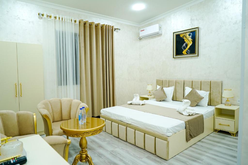 a hotel room with a bed and a chair at Astoria Inn Hotel in Toshkent-Passajir Bekati