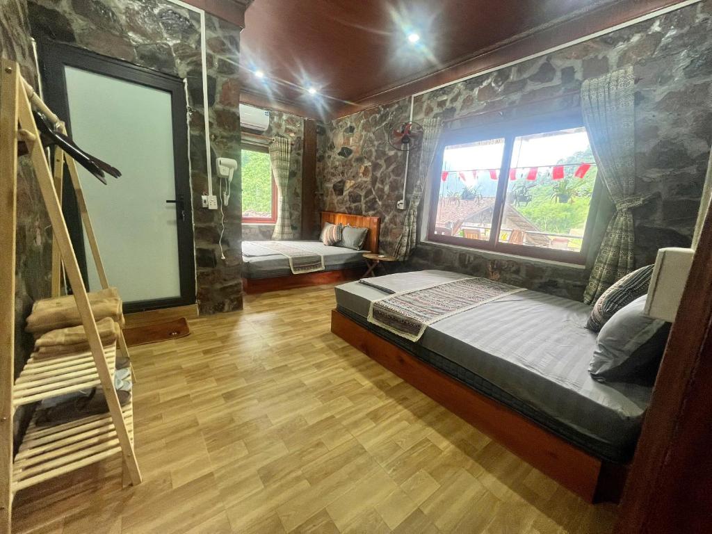 a room with a bed and a window in it at A THÁM homestay in Dam Thuy