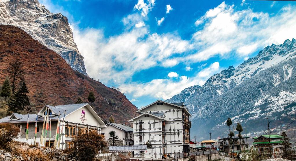 a building in front of a mountain at Valmere Bayul Shangri-La Resort in Lachung