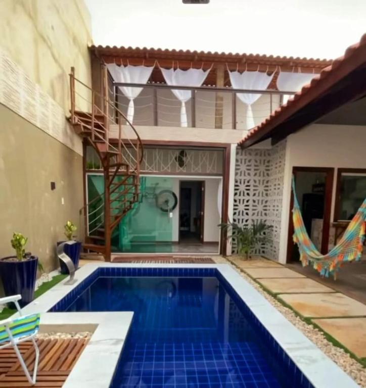a villa with a swimming pool and a house at Casa 3 amores PREÁ, vento, charme, piscina e 2 quartos in Prea
