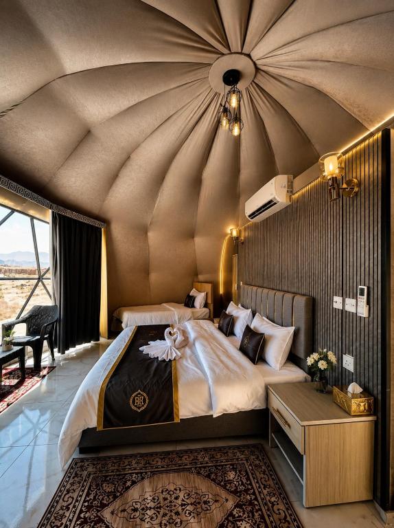 a bedroom with a large bed with a large ceiling at Solara Rum Camp in Wadi Rum