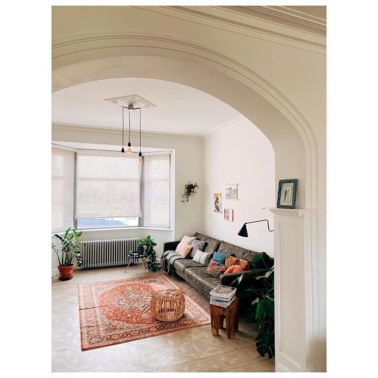 an archway in a living room with a couch at Centrally located spacious family home in Tienen