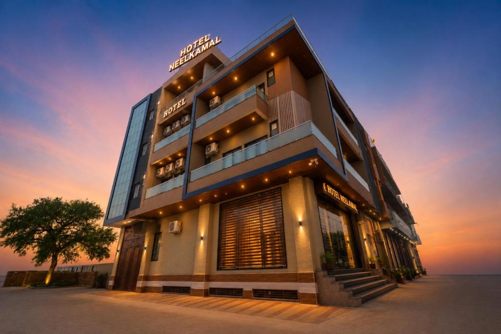 a building with a sunset in the background at Hotel Neel Kamal-Near KhatuShyamJi Temple in Khātu