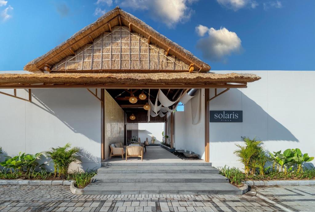 a view of the lobby of a resort with a thatched roof at Solaris Villa Bali in Kuta