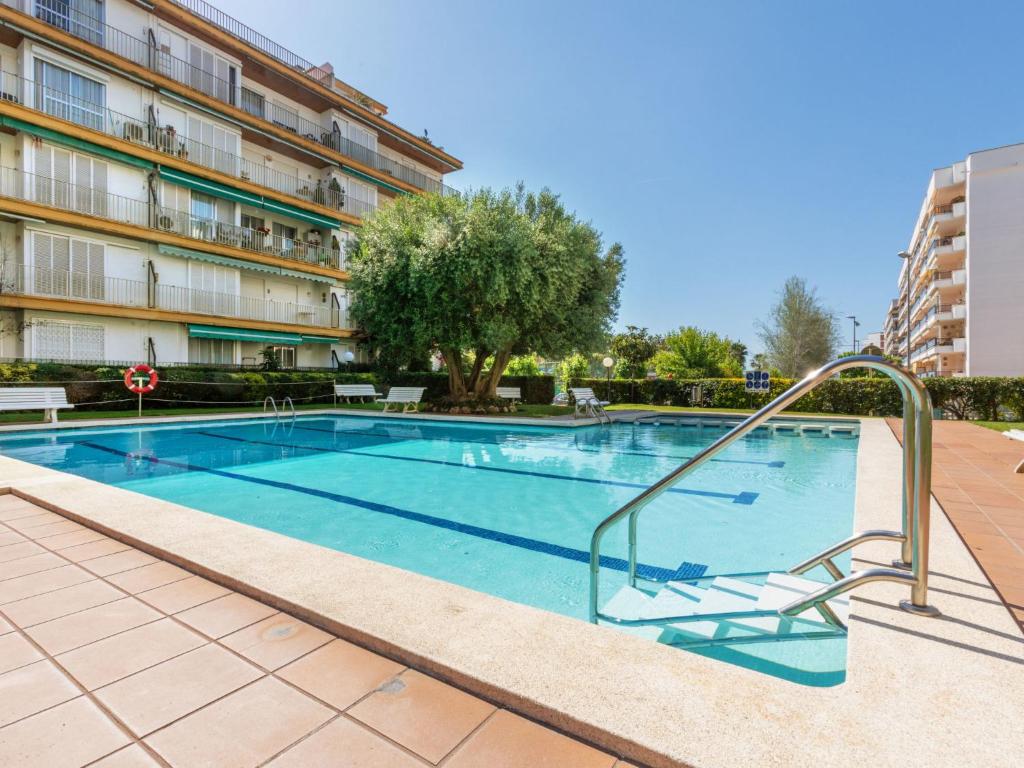 a swimming pool in front of a building at Apartment Buenos Aires by Interhome in Lloret de Mar