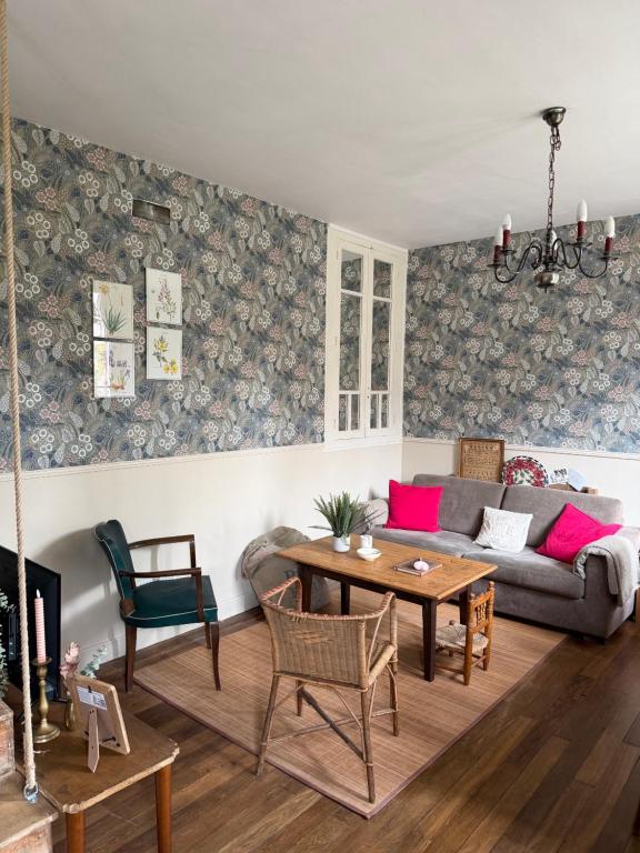 a living room with a couch and a table at Maison Bécharie in Uzerche