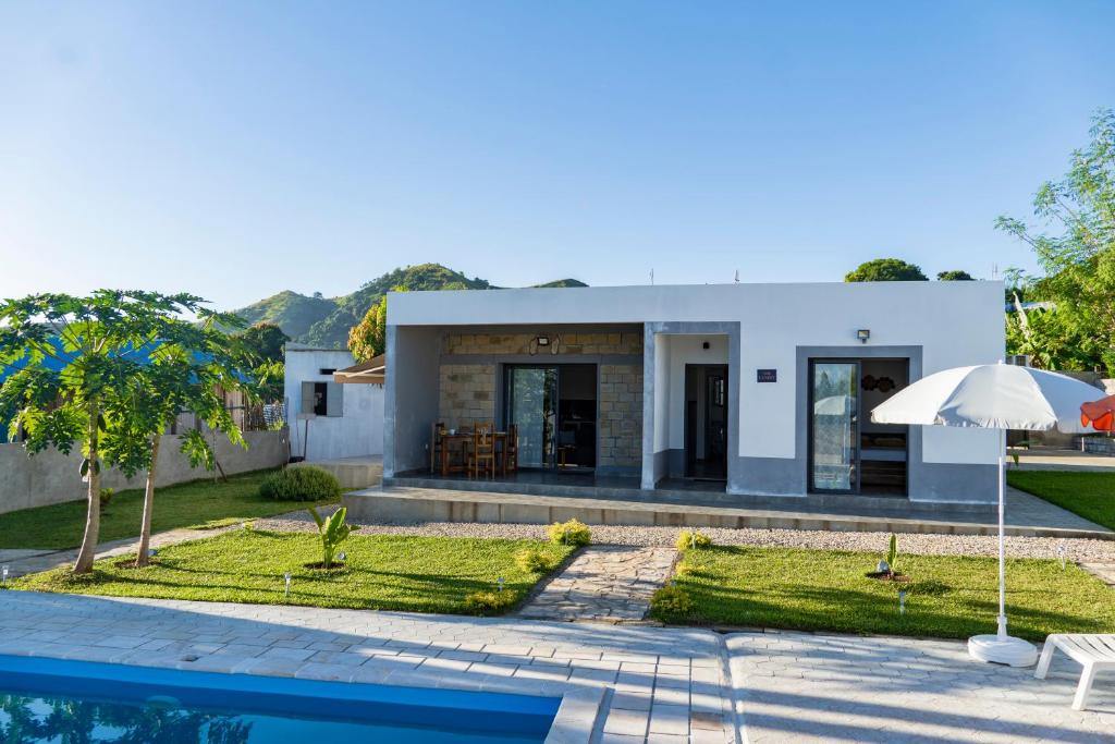 a villa with a swimming pool and a house at Résidence Vahi-Ni, Villa Faniry in Hell-Ville
