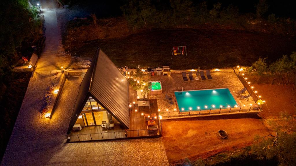 an overhead view of a swimming pool at night at BEV's Hideaway in Gornji Kosići