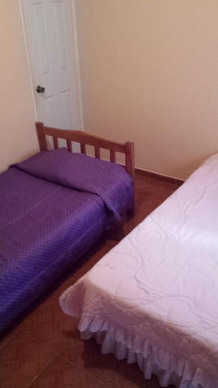 Postel nebo postele na pokoji v ubytování Hospedaje Rampolla's