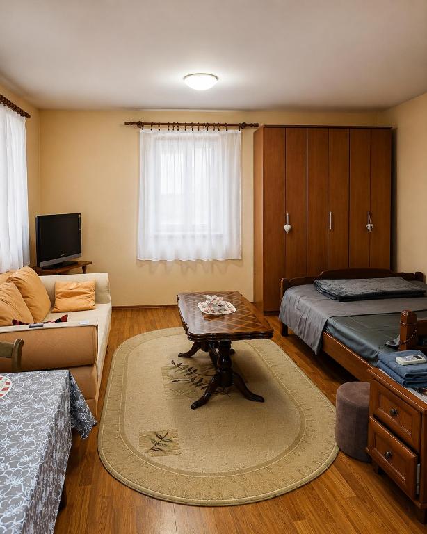 a bedroom with a bed and a coffee table in it at Native Apartments in Budva