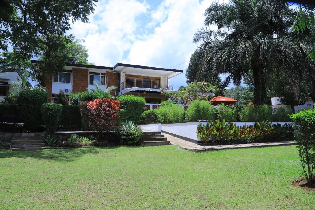 a house with a garden in front of it at Rocy Hotel in Mbale