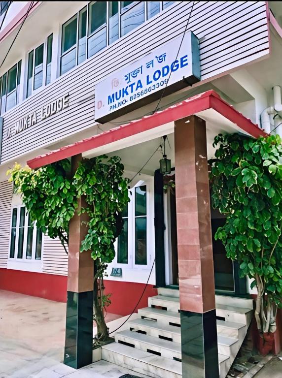 a building with a sign that reads mulka lodge at D Mukta Lodge in Guwahati