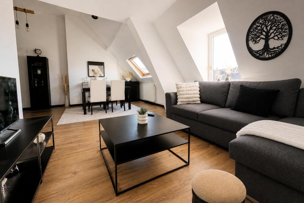 a living room with a couch and a table at Les Toits d'Arras in Arras