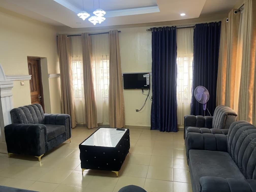 a living room with two couches and a table at Ined Apartment Services in Ibadan