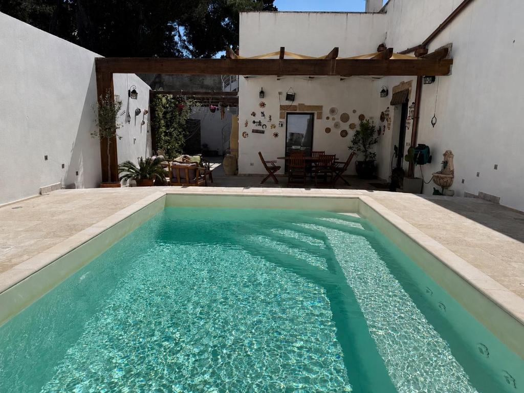 a swimming pool in front of a house at CasaSignorina in Leuca