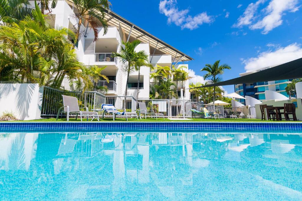 a hotel room with a pool and a balcony at Beach Club Resort Mooloolaba in Mooloolaba