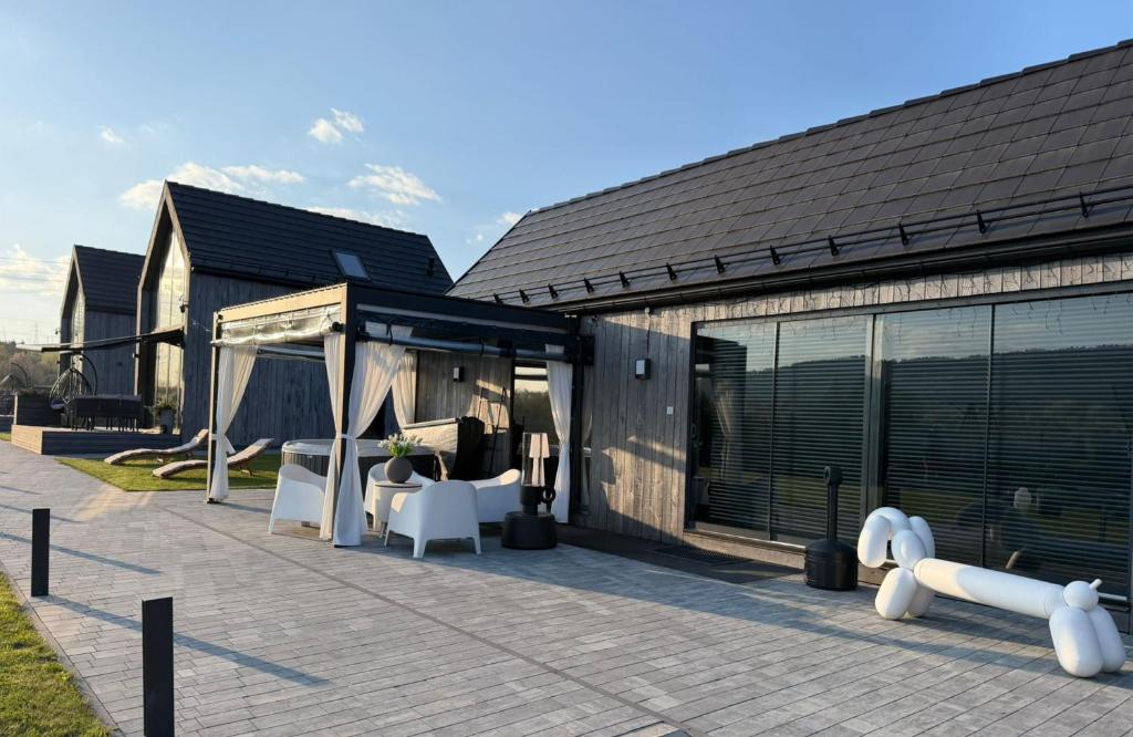 a house with a patio with a gazebo at Sunset House & Spa in Ustrzyki Dolne