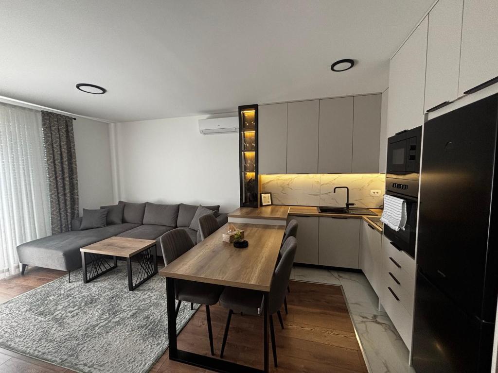 eine Küche und ein Wohnzimmer mit Sofa und Tisch in der Unterkunft Apartment Viewpoint in Posušje