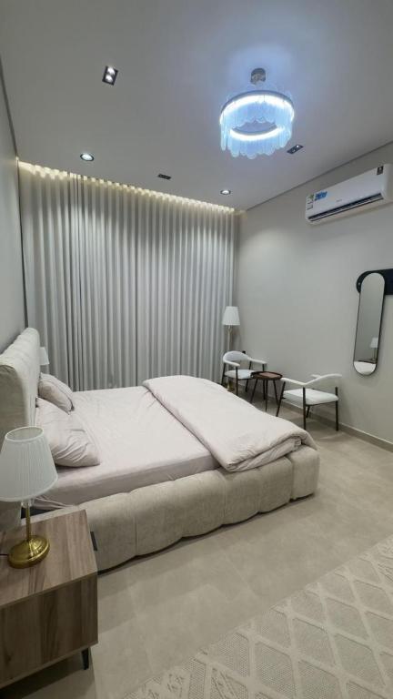 a bedroom with a large bed and a blue ceiling at the garden in Hail