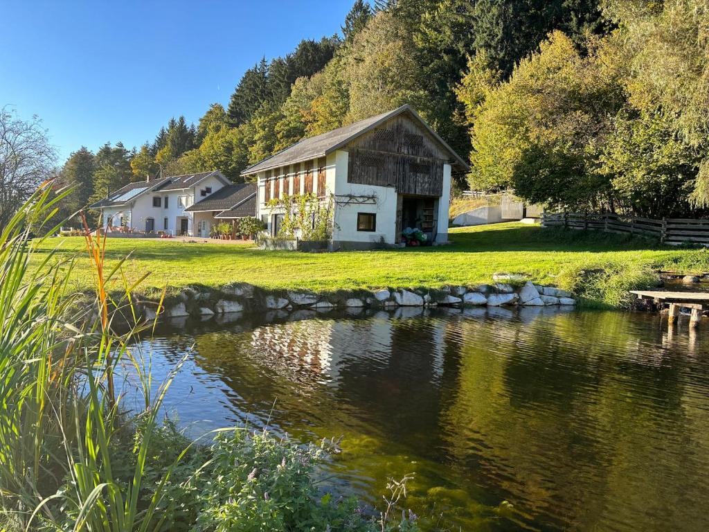 a building next to a river with a stone bridge at Sternberg Landhof in Sternberg