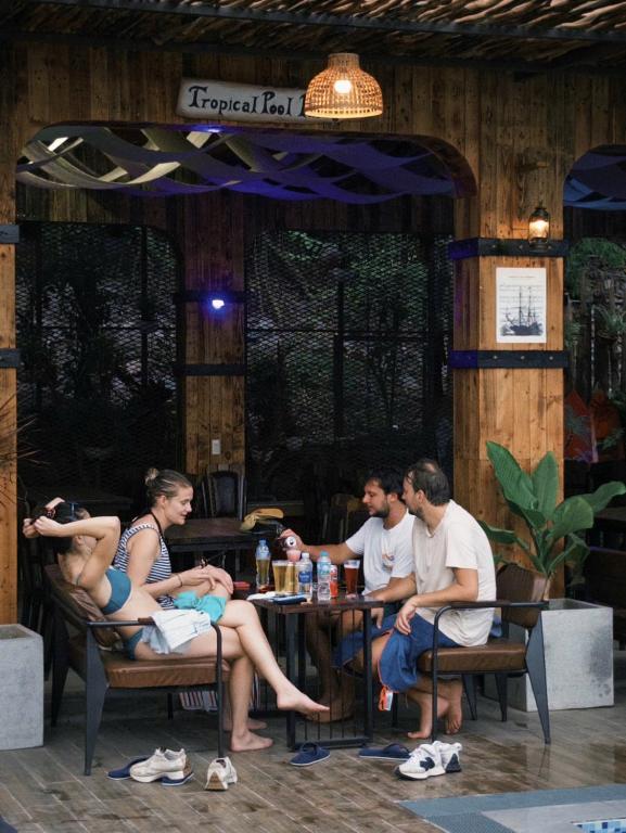 a group of people sitting at a table in a restaurant at Hung Long Harbour Hotel in Cat Ba