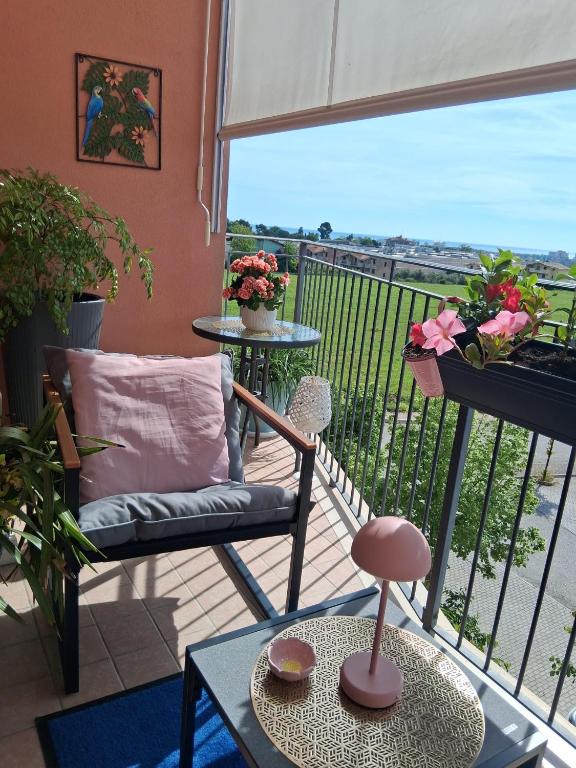 a room with a balcony with a chair and a table at B&B Come a Casa in Citta' Sant'Angelo