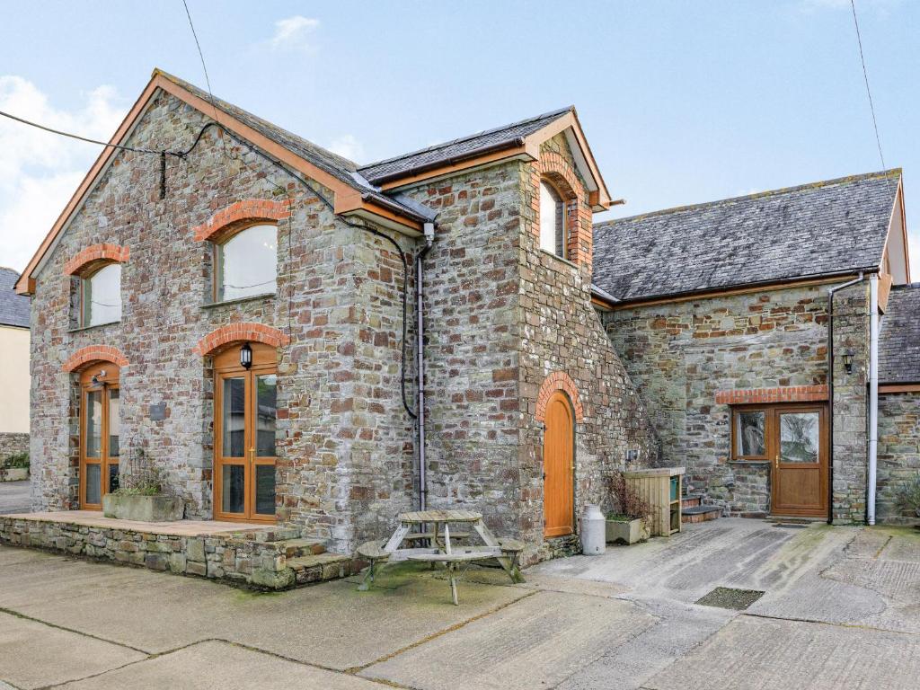a brick house with a table in front of it at The Granary - Uk35755 in Bideford